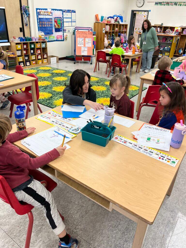 Elementary classroom with students working at tables